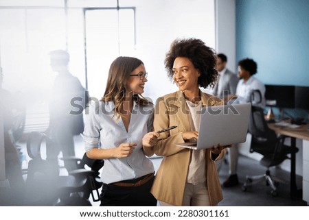 Happy multiethnic smiling business women working together in office