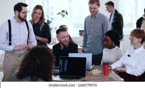Happy multiethnic smiling group working together at loft office, brainstorming with middle aged boss at conference. - Shutterstock ID 1636779973