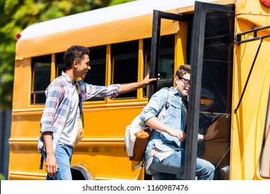 Happy Multiethnic Teen Schoolboys Walking At School Bus