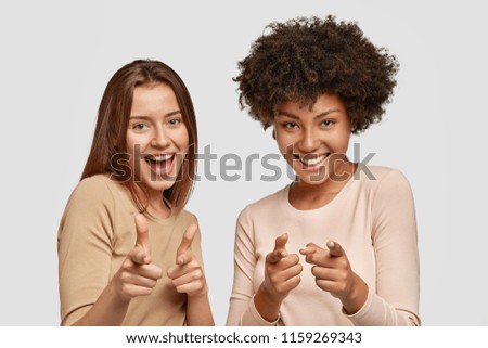 Similar – Image, Stock Photo smiling girls best friends lying on beach while looking camera