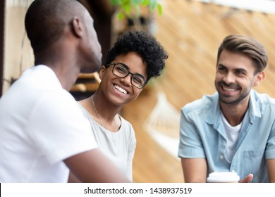 Happy Multiethnic Young People Relax Together Have Fun Talking And Chatting Sharing Ideas, Smiling Multiethnic Diverse Friends Speak Resting Hanging Out In Coffeeshop. Communication Concept