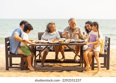 Happy Multi-Generation Asian family having celebration dinner food and drink together at tropical beach restaurant during travel ocean on summer holiday vacation at sunset. Family relationship concept - Powered by Shutterstock