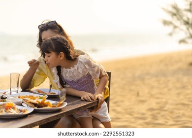 Happy Multi-Generation Asian family having celebration dinner food and drink together at tropical beach restaurant during travel ocean on summer holiday vacation at sunset. Family relationship concept - Powered by Shutterstock