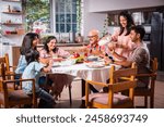 Happy multi-generation asian Indian family enjoying lunch together at home.