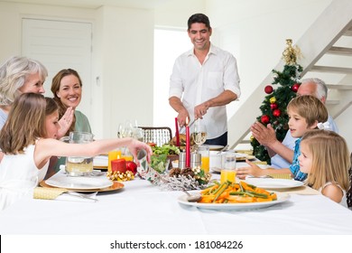 Happy Multigeneration Family Enjoying Christmas Meal At Dining Table