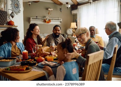 Happy multigeneration family gathering for Thanksgiving meal at dining table.  - Powered by Shutterstock