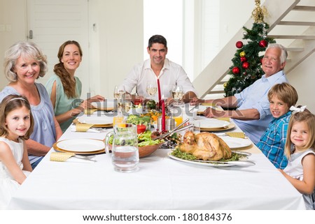 Happy multigeneration family having Christmas meal together at dining table
