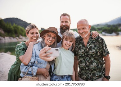 Happy Multigeneration Family On Hiking Trip On Summer Holiday, Taking Selfie.