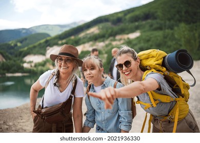 Happy Multigeneration Family On Hiking Trip On Summer Holiday, Pointing At Something.