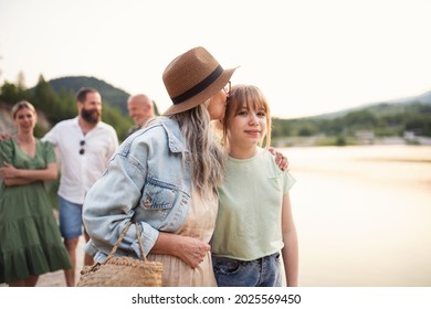 Happy Multigeneration Family On Summer Holiday, Walking By Lake.