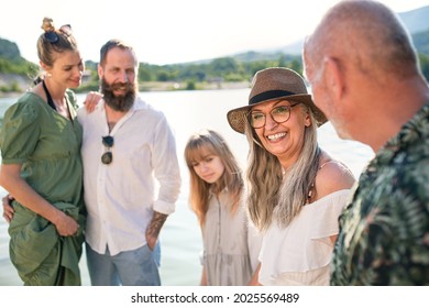 Happy Multigeneration Family On Summer Holiday, Walking By Lake.