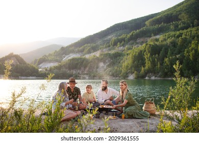 Happy Multigeneration Family On Summer Holiday Trip, Barbecue By Lake.