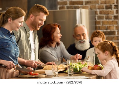 happy multigeneration family preparing dinner together in kitchen - Powered by Shutterstock