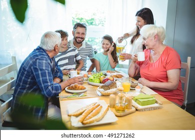 Happy multi-generation family sitting at breakfast table - Powered by Shutterstock