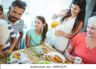 Happy multi-generation family sitting at breakfast table - Powered by Shutterstock