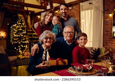 Happy multigeneration family spending Christmas together and looking at camera. - Powered by Shutterstock