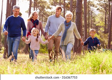 Happy multi-generation family walking in the countryside