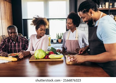 Happy multigenerational african american family make dinner together. - Powered by Shutterstock