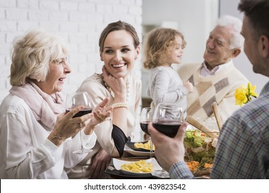 Happy multi-generational family gathering during holidays at the table