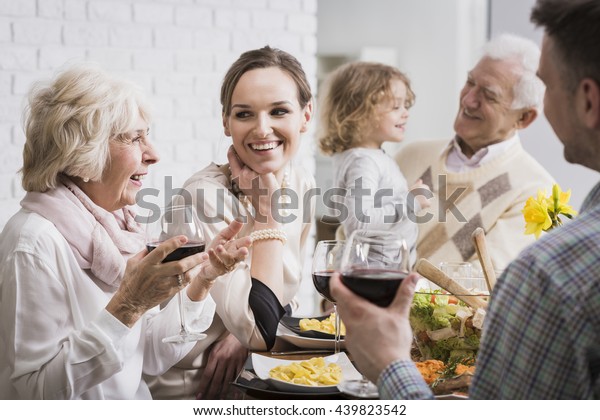 Happy multi-generational family gathering during\
holidays at the table