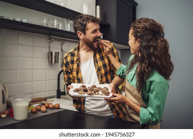 Happy multiracial couple have made cookies in their kitchen. - Powered by Shutterstock