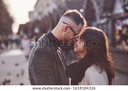 Happy multiracial couple together outdoors in the city. Asian girl with her caucasian boyfriend.