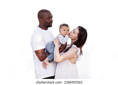 Happy Multiracial Family. Caucasian Mom And African American Dad Kiss Small Baby. Parents, Portrait Of Mother, Father And Child On Hands Isolated On White Background