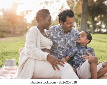 Happy Multiracial Family Enjoy Day At Park - Pregnant African Mother, Caucasian Father And Mixed Race Son Enjoy Day Outdoor