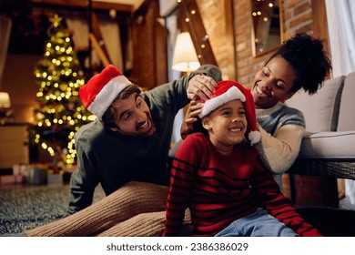 Happy multiracial family having fun while spending Christmas eve together.  - Powered by Shutterstock