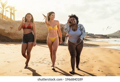 Happy Multiracial Females With Different Body Size Having Fun Walking On The Beach During Summer Holidays