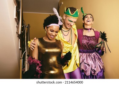 Happy Multiracial Friends In Carnival Costumes Laughing While Going On Mardi Gras Party. 