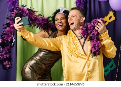 Happy Multiracial Friends Celebrating Mardi Gras And Taking Selfie With Cell Phone.