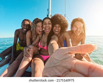 Happy multiracial friends doing tour with sailing boat - Soft focus on center girl face - Powered by Shutterstock