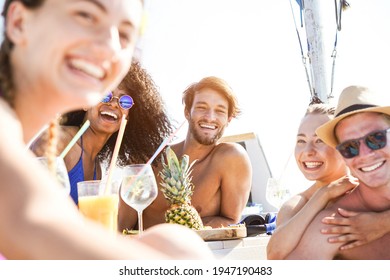 Happy Multiracial Friends Drinking Tropical Cocktails At Boat Party - Young People Having Fun In Sea Tour - Summer Vacation And Travel Concept - Focus On Left Man Face