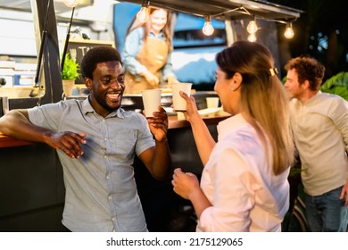 Happy multiracial friends having fun drinking beer in a street food truck market - Shutterstock ID 2175129065