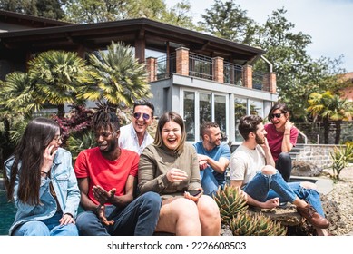 Happy multiracial friends on holiday in a luxury house standing at the poolside - Powered by Shutterstock