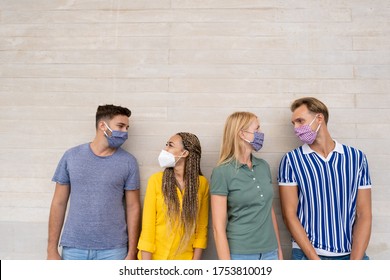 Happy Multiracial Friends Smiling And Look Eachother - Group Of Mixed Race People Wearing Protective Face Mask - Concept Of Health Care And Social Contact In Time Of Coronavirus