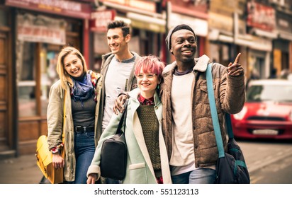 Happy Multiracial Friends Walking On Brick Lane At Shoreditch London - Friendship Concept With Multicultural Young People On Winter Clothes Having Fun Together - Soft Focus With Dark Contrasted Filter