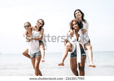 Happy multiracial girls with different culture having fun on the beach during summer holidays,Group of international people making the hand connection, Multiethnic group of young happy friends bonding