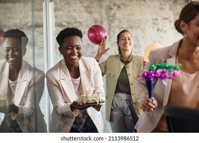 Happy multiracial group of businesswomen having fun while celebrating on surprise party in the office. Focus is on African American businesswoman with a cake. - Powered by Shutterstock