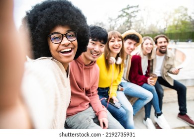 Happy Multiracial Group Of Friends Taking Selfie Picture Outside - International Students Having Fun Together Sitting In College Campus - Friendship Lifestyle Concept With Guys And Girls Hanging Out  