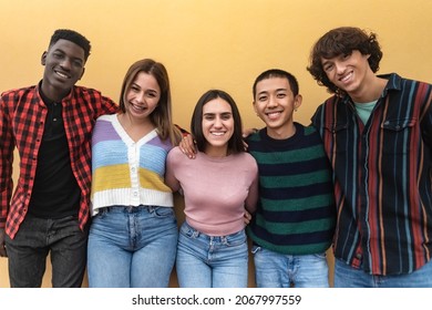 Happy multiracial group of teenagers having fun outside school - Young people lifestyle concept