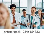 Happy multiracial medical students going to a lecture at the university amphitheater.