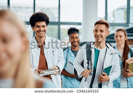 Happy multiracial medical students going to a lecture at the university amphitheater.