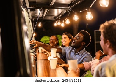 Happy multiracial people buying meal from food truck kitchen - Powered by Shutterstock