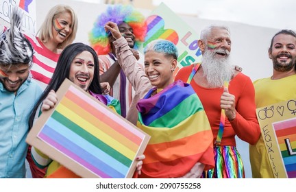 Happy multiracial people dancing at pride parade - Concept of LGBT, multi generational and diverse people - Shutterstock ID 2090755258