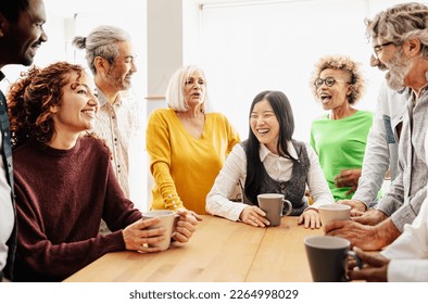 Happy multiracial people with different ages and ethnicities having a break during work time  - Powered by Shutterstock