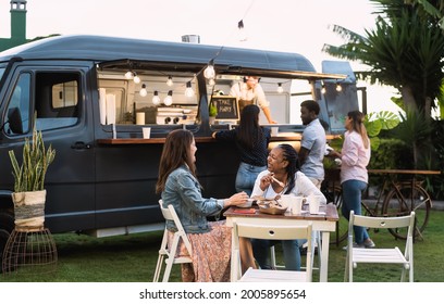 Happy Multiracial People Having Fun Eating In A Street Food Truck