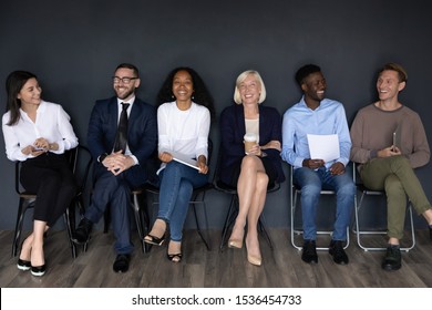 Happy multiracial professional business people young and old applicants group sit on chairs laughing having fun wait for job interview sit in row queue, human resource, staffing employment concept - Shutterstock ID 1536454733
