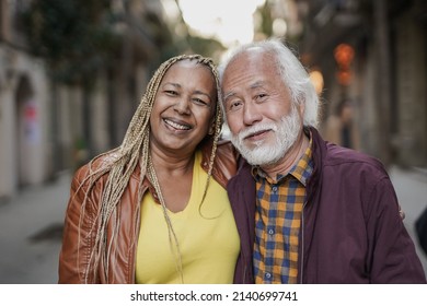 Happy Multiracial Senior Couple Smiling On Camera Outdoor